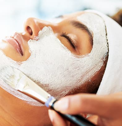 woman receiving facial service
